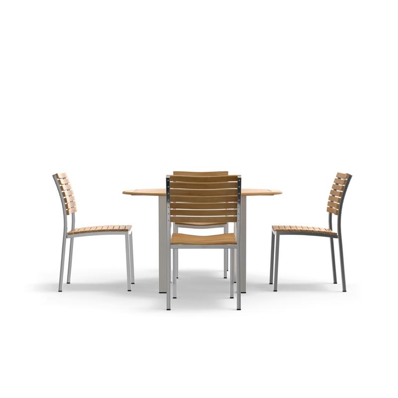 alt="70438 Vogue Dining Set for 4 of Vogue Teak and Stainless Steel 48 inch Round Dining Table and 4 Vogue Side Dining Chairs in angled side view on white background"