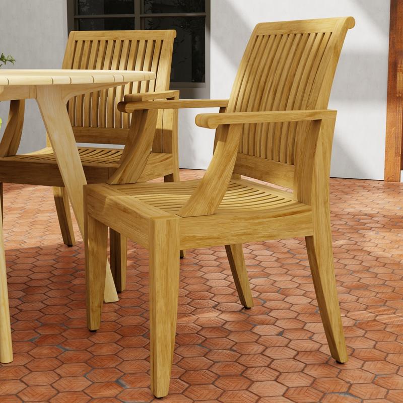 alt="70544 Laguna Surf 5 pc Dining Set showing closeup view of Laguna Dining Armchair in angled side view on tiled patio with house in background"