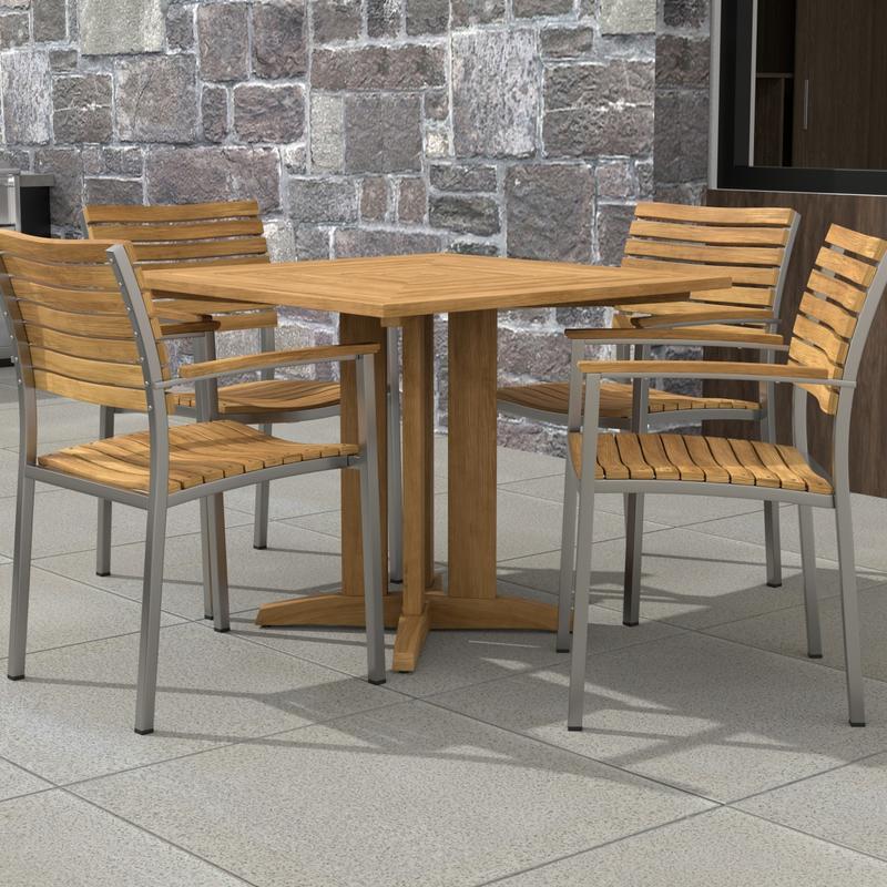 alt="70575 Vogue Pyramid 5pc Dining Set in angled corner view of table top on patio with a stone wall in background"