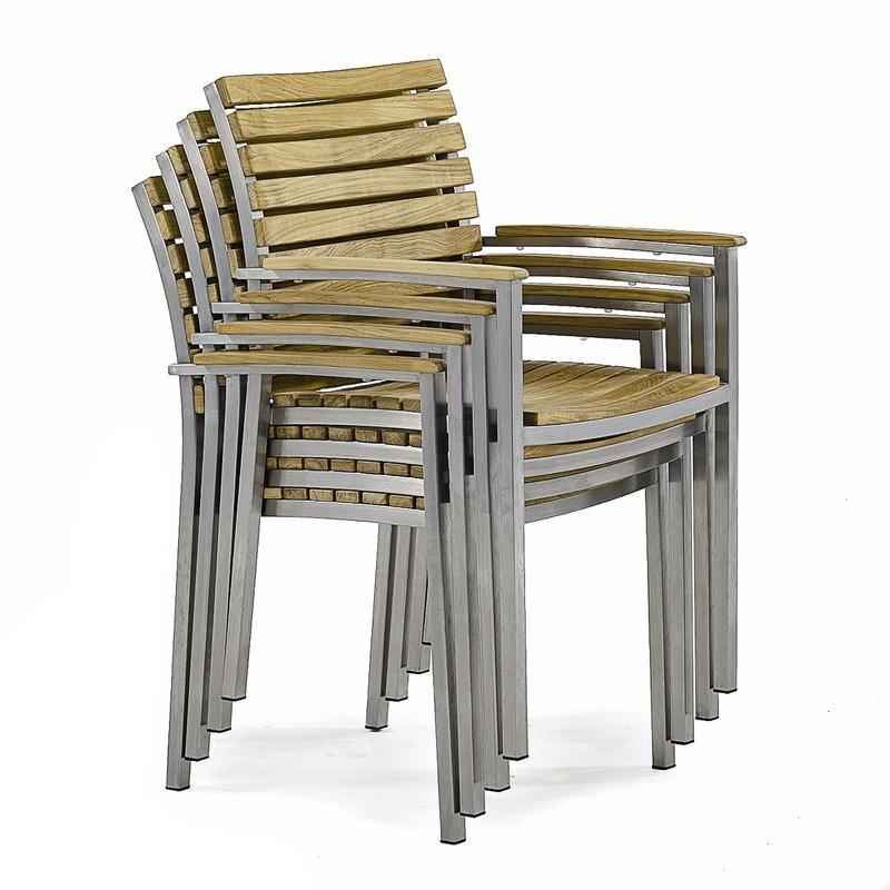 alt="22007 Vogue teak and stainless steel armchair angled stacked 4 high on white background"