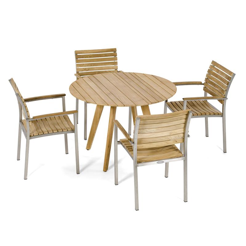 alt="70548 Vogue Surf  5 pc Dining Set of 4 Vogue Teak and Stainless Steel Dining Armchairs around a Surf 42 inch Round Teak Table angled on white background"