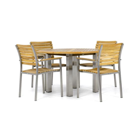 70625 Vogue Round Teak Dining Set of  4 Vogue teak and stainless steel dining Armchairs around a Vogue 48 inch Round Teak Table in side view on white background