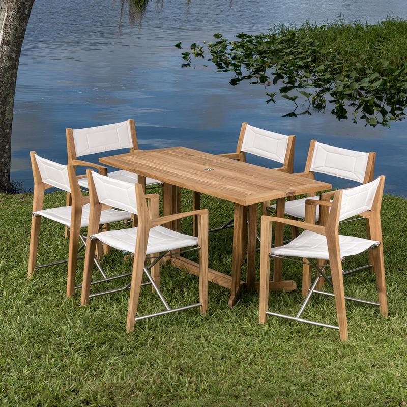alt="70471 Odyssey Nevis Folding Dining Set on grass field with lake in background"