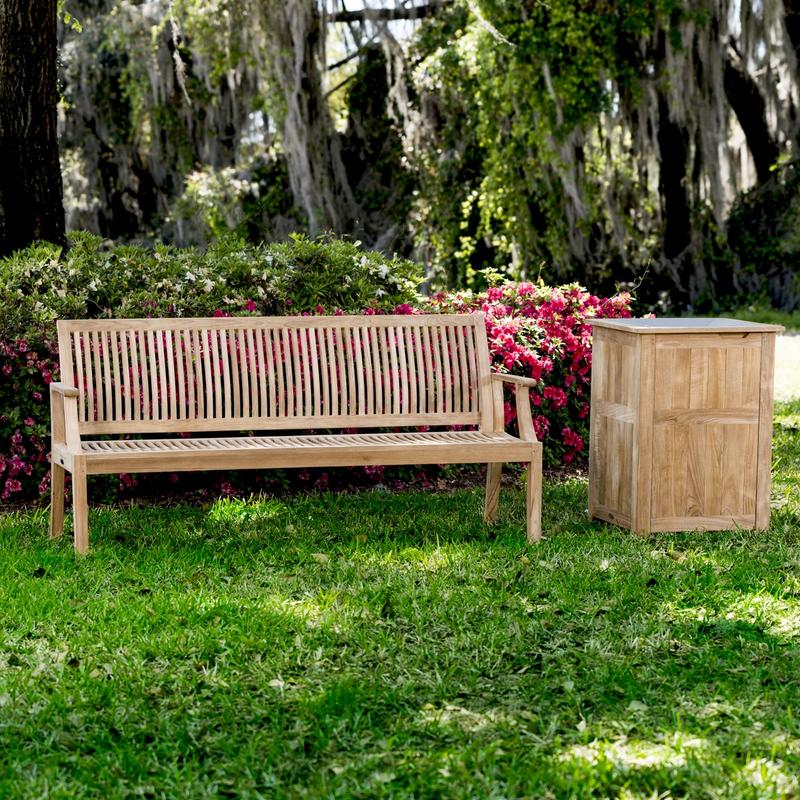 alt="13812 Laguna 5 foot long Teak Bench beside teak Palazzo I trash receptacle on grass with flowering shrubs in background"