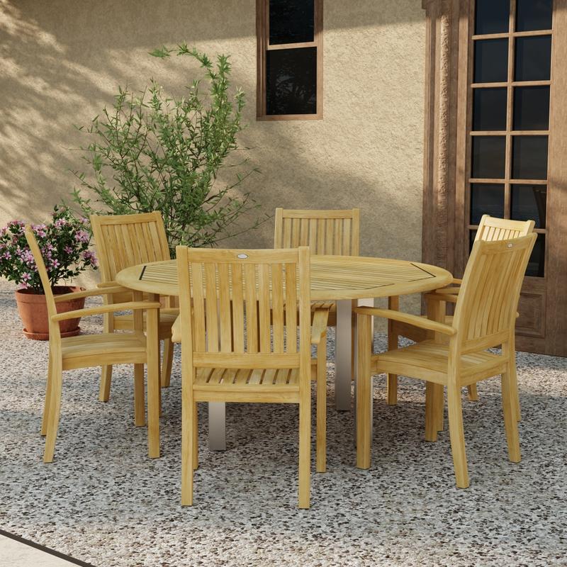 alt="70358 Vogue Sussex 7 pc Dining Set of Vogue 60 inch Round Table and 6 Sussex Armchairs in angled side view on patio with 2 potted plants next to window and french door in background"