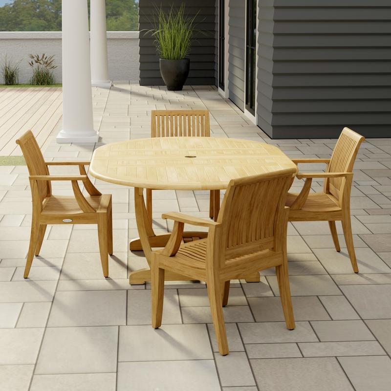 alt="70305 Martinique 5 piece Dining Set angled end view on stone patio with 2 pillars of house with a plant and trees and privacy wall in the background  "