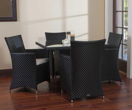 alt="32002BK Valencia 40 inch Square Wicker Table with candle holder on glass table top and 4 Valencia armchairs on wood floors and wall mirror in back and patio door to outside"