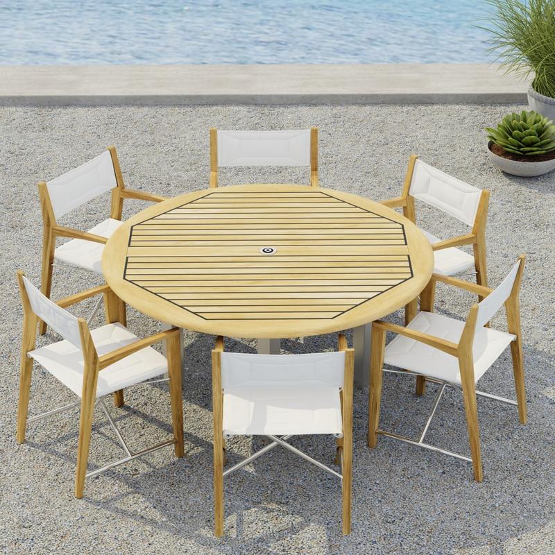 alt="70359  Vogue Odyssey 7 pc Dining Set showing Vogue 5 ft Round Table and 6 Odyssey Chairs on terrace angled aerial view with 2 potted plants and ocean in the background"