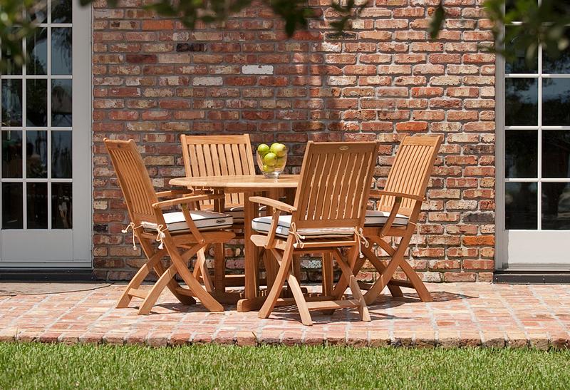alt="70066 Barbuda Round 5 piece Folding Dining Set on brick patio with house and french patio doors in background"