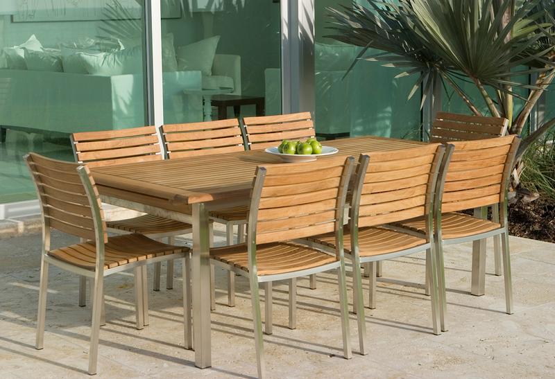 alt="21007ST Vogue Side Chair showing with 11 piece Vogue Dining Set on concrete patio with glass patio doors in background"