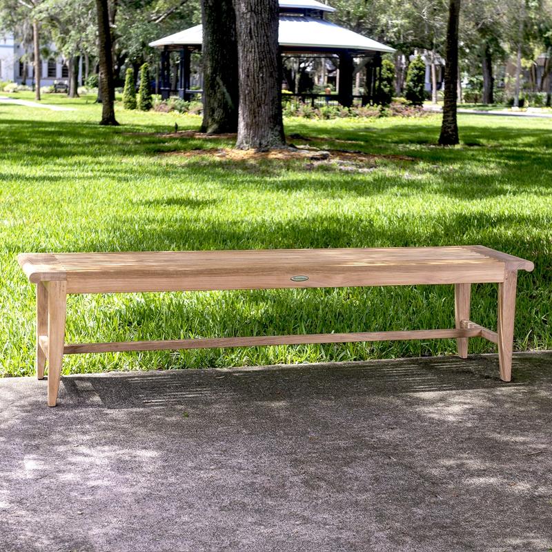 alt="13916 Laguna teak backless garden bench on concrete walkway with grass trees and gazebo in background"