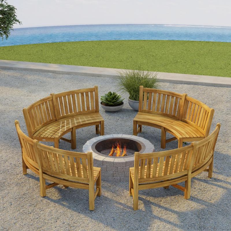 alt="70657 Buckingham Bench Set of 4 around a firepit on outdoor patio next to 2 potted plants in angled aerial view with grass lawn and ocean and blue sky in the background"