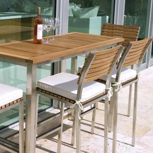 alt="21510ST Vogue Bar Stool set right view with optional canvas color cushion on seat on concrete patio in front of vogue rectangular bar table with wine bottle and two wine glasses"