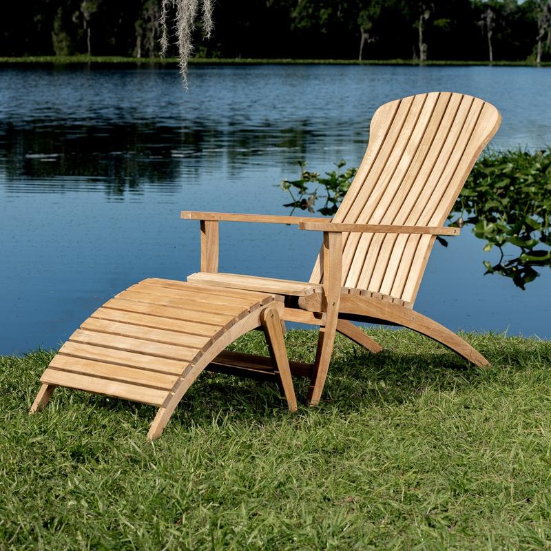 alt="70000 Adirondack Chair and Footrest in angled side view on green grass with lake background"