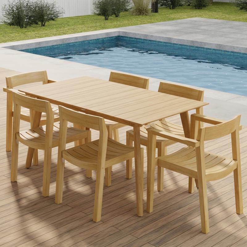alt="70525 Surf Horizon 7 pc Dining Set of a Surf Teak 60 inch Rectangular Table angled aerial view on patio in front of a pool with grass and landscaping plants and trees and white fence in the background"