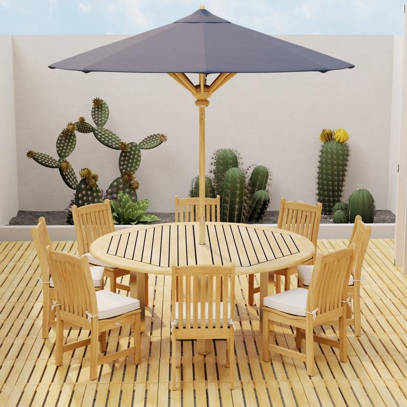 alt="18490 Callebotise Teak Floor Tiles  on an outdoor patio in an angled view with a dining set and optional umbrella and a privacy wall with cactus plants in background "