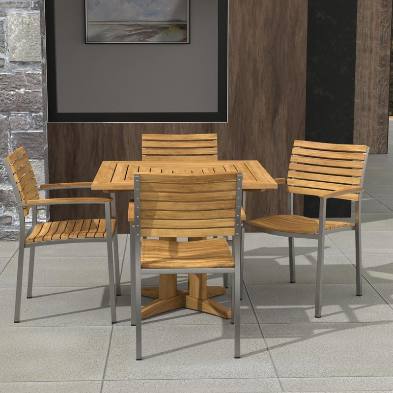 alt="70575 Vogue Pyramid 5pc Dining Set of Pyramid 36 inch Square Dining Table and 4 Vogue Teak and Stainless Steel Stacking Arm Chair on patio with a picture and window in background"