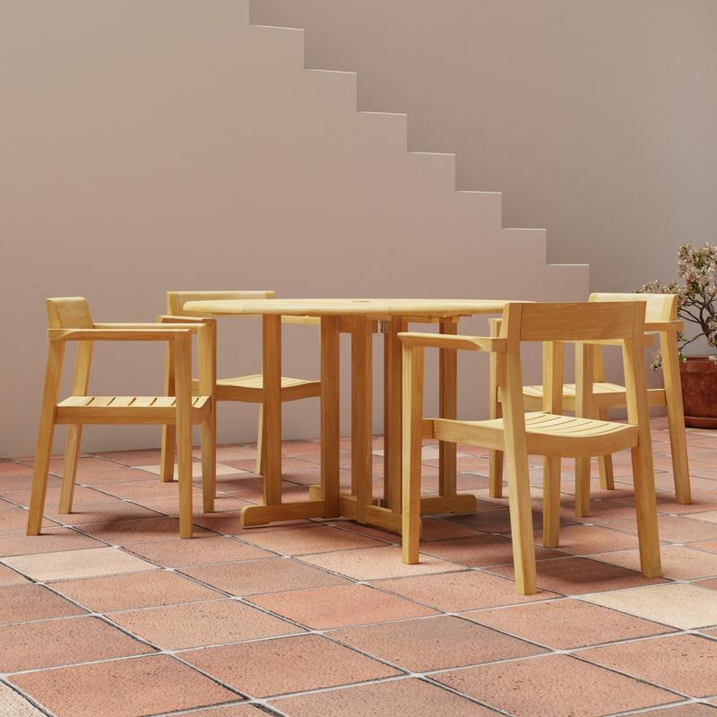 alt="70384 Barbuda Horizon Teak Dining Set of Barbuda 48" Round Folding Table and 4 Horizon Armchairs angled view on tiled patio  with staircase in background"