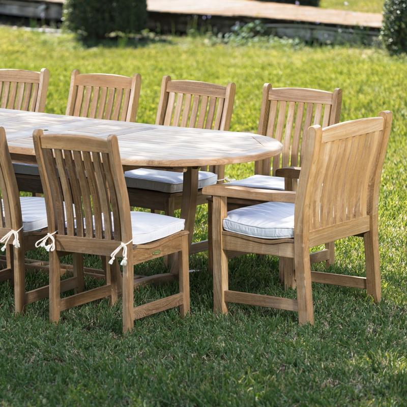 alt="70008 Montserrat Veranda eleven piece oval dining set side view showing seat cushions on a grass field "