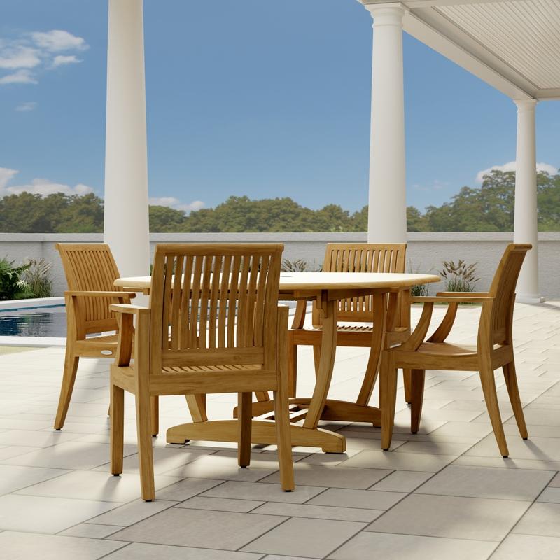 alt="70305 Martinique 5 piece Dining Set  angled end view on stone patio with 3 pillars and pool and trees and privacy wall in the background  "