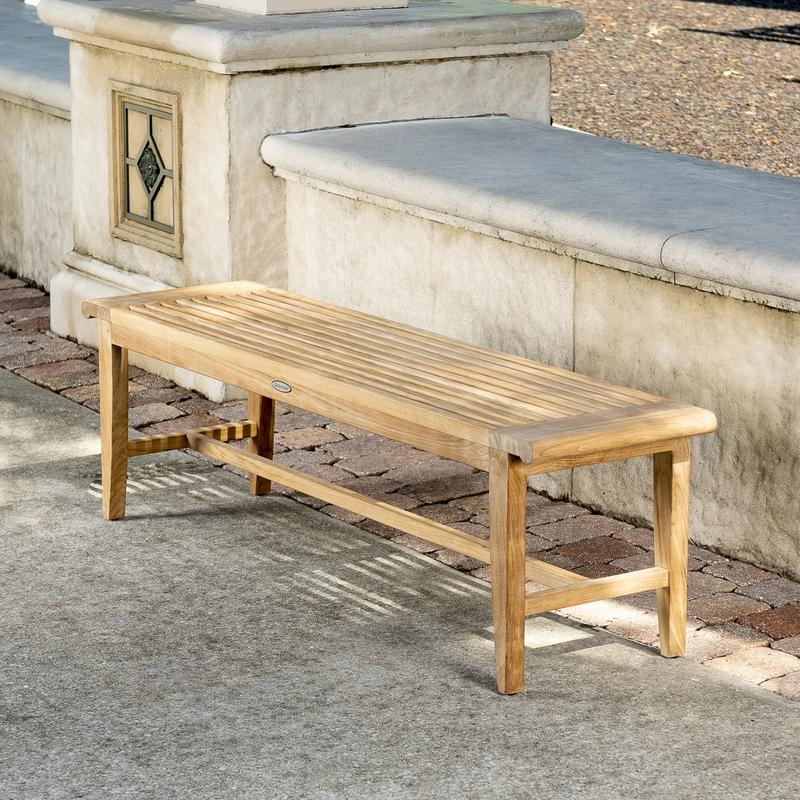 alt="13916 Laguna Teak 5 foot Backless Bench angled view on concrete stone patio with concrete low wall in background"