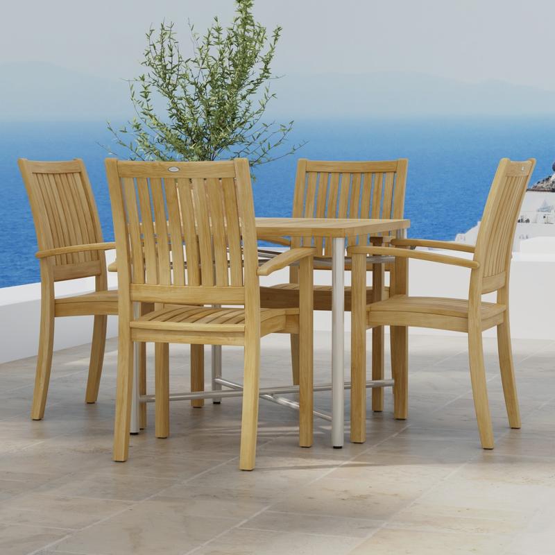 alt="70597 Odyssey Sussex 5 pc Dining Chair Set of Odyssey Square Table and 4 Sussex Dining Chairs in side view on stone tiled terrace with potted plant and ocean and blue sky in the background "
