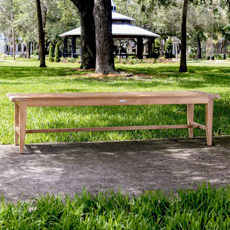 alt="13917 Laguna 6 foot teak Backless Bench on concrete walkway with trees and pavilion in background"