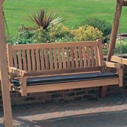 alt="13955bo veranda swinging bench and stand with optional bench cushion on brick patio overlooking grass field with shrubs in background"