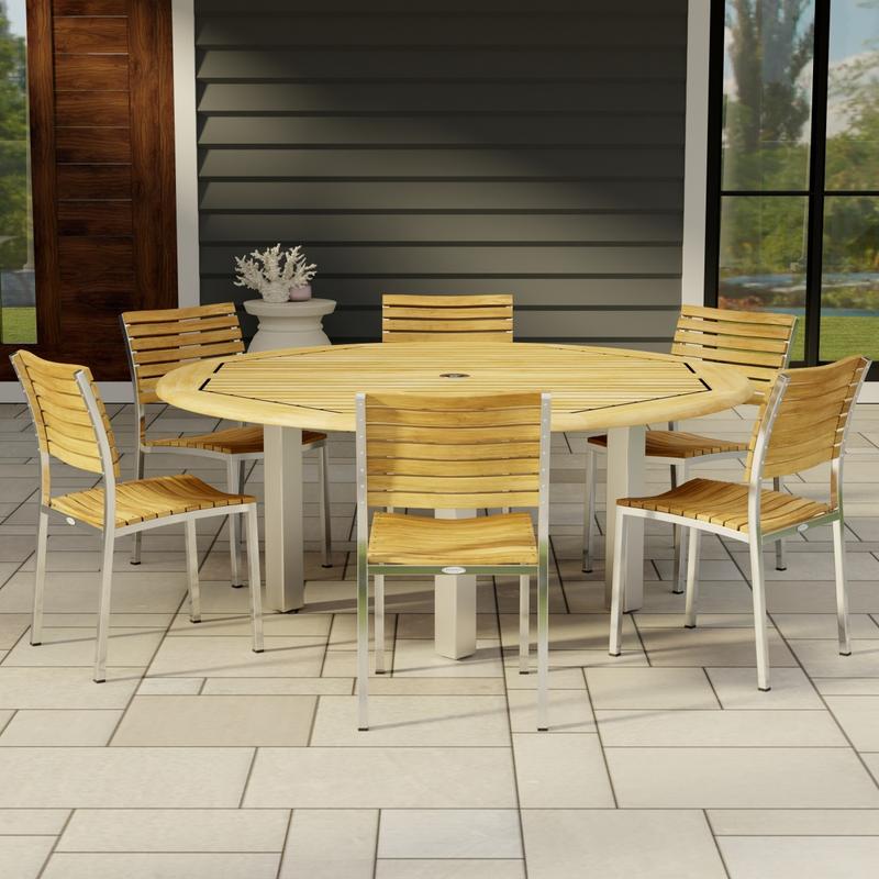 alt="70428 Vogue 7pc Round Dining Set of Vogue Round DIning Table and 6 Vogue Side Chairs in side view on tile patio with window and door of house in background"