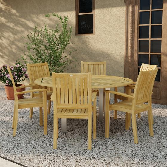 70358 Vogue Sussex 7 pc Dining Set of Vogue 60 inch Round Table and 6 Sussex Armchairs in angled side view on patio with 2 potted plants next to window and french door in background