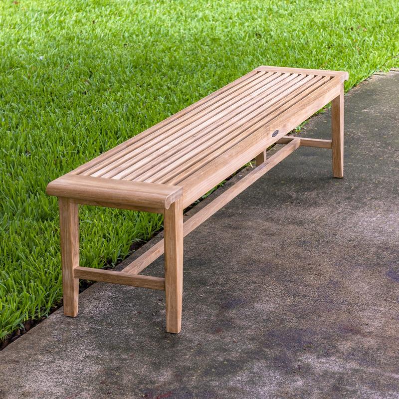 alt="13917 Laguna 6 foot teak Backless Bench on concrete walkway with grass in background"
