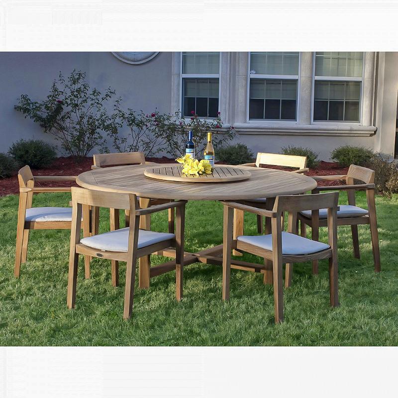 alt="70238 Buckingham Horizon teak dining set with 2 wine bottles and yellow flowers on lazy susan in center of table and optional seat cushions on grass landscape plants and house in back"