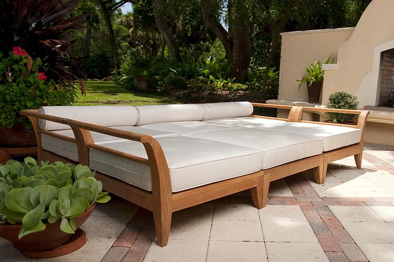 alt="70100 Aman Dais 6 pc Daybed Set with cushions right side angled on stone patio three potted plants outdoor fireplace trees grass in background"