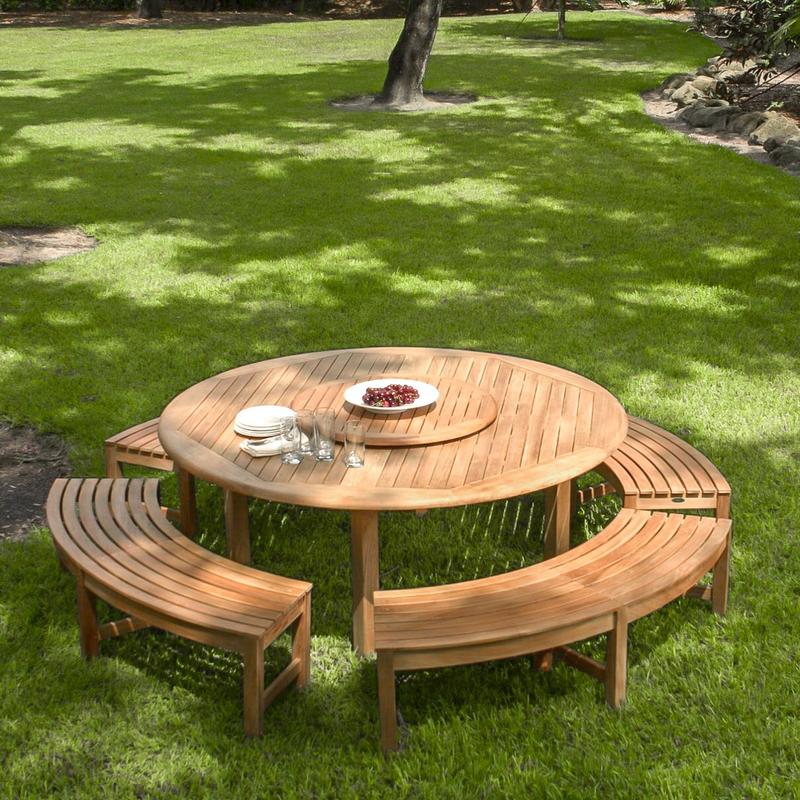 alt="13937 Buckingham Picnic Dining Set with white bowl of grapes 4 white plates stacked and 4 glasses on table top set on grass field angled aerial view with trees in background"