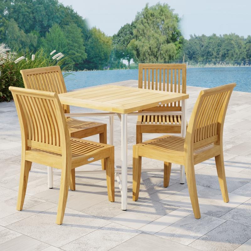 alt="70595 Odyssey Laguna Dining Set showing Odyssey Teak and 316L Stainless Steel 32 inch Square Dining Table and 4 Laguna Side Chairs angled on patio with plants and waterview in background"