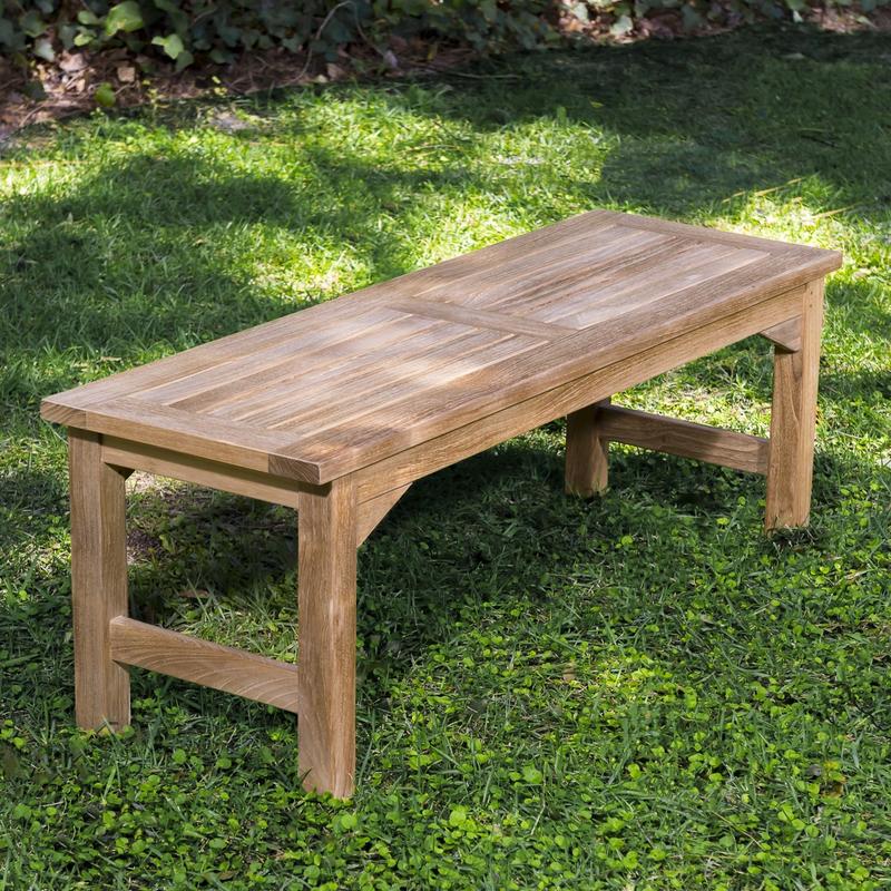 alt="13940 Veranda 4 foot Teak Backless Bench angled aerial view on grass area with trees & shrubs in background"