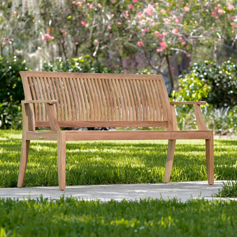 alt="13811 Laguna 5 foot Teak Bench on concrete walkway showing grass lawn in front and behind bench with landscape shrubs and trees in background   "