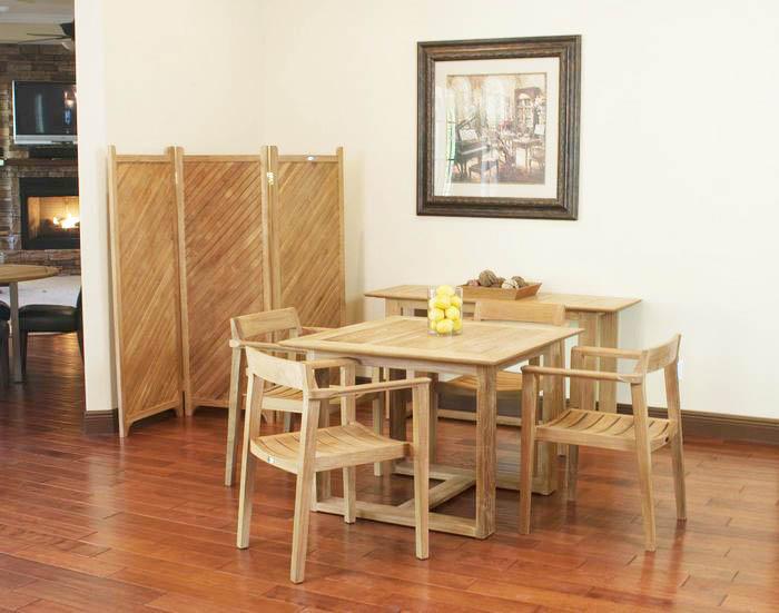 alt="70174 Horizon 5 piece Square Dining Set indoors on wood floor with lemons on table center and teak privacy screen and wall picture in background "