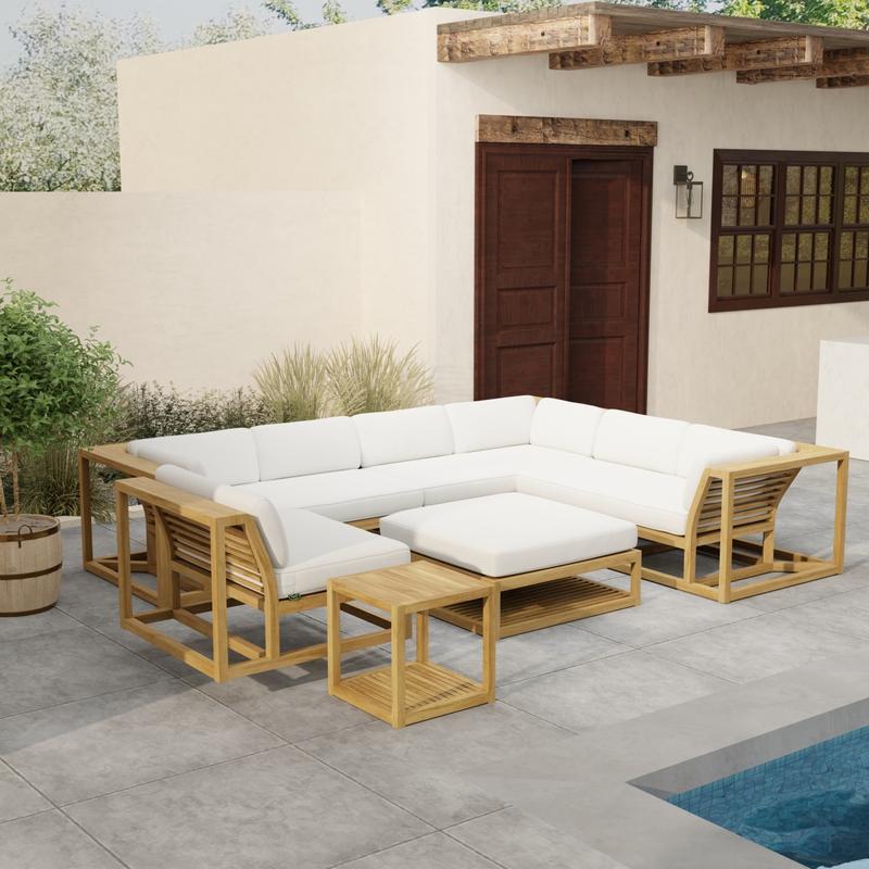 alt="70273 Maya 6pc Sectional Set side angled on patio next to a pool with landscaping plants a door and window of house in background "