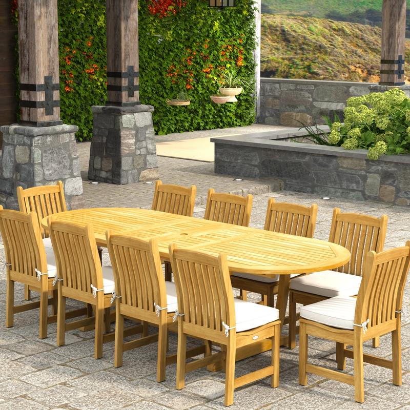 alt="70166 Montserrat Veranda 11pc Dining Set with optional cushions on patio in angled aerial view with pergola with hanging plants and vines and landscape plants and hillside in background"
