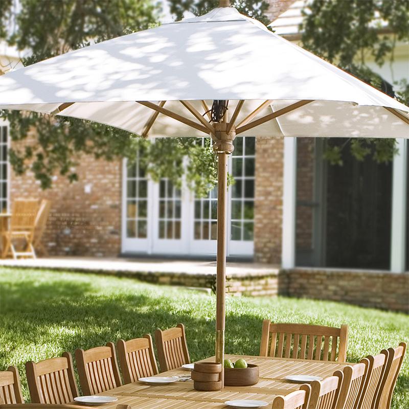 alt="17640 grand ten foot rectangular teak umbrella in dining set bowl green apples bowls and place setting on lawn with brick house and trees in background "