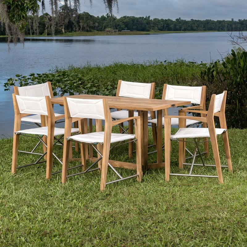 alt="70471 Odyssey Nevis Folding Dining Set on grass field with lake and trees in background"