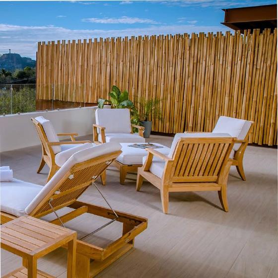 70906 Laguna Chair & Ottoman Set for 4 with cushions angled on a patio with fence in the background