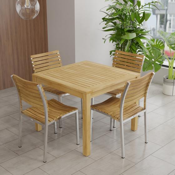 70426 Vogue 5 piece Cafe Set of Bistro Teak 36" Square Dining Table and 4 Vogue teak and stainless steel side chairs in tiled room with panel wall and tall windows and potted plants in background