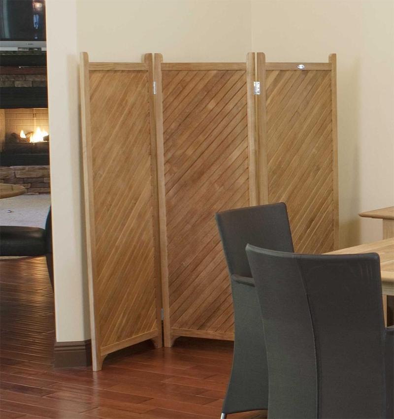 alt="18252 Veranda folding Privacy Screen opened on indoor wooden floor against wall with two black armchairs in front"