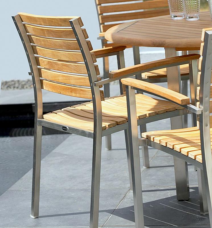 alt="70563 Surf Vogue 5 piece Dining Set closeup of back side of armchair on tiled patio outdoors"