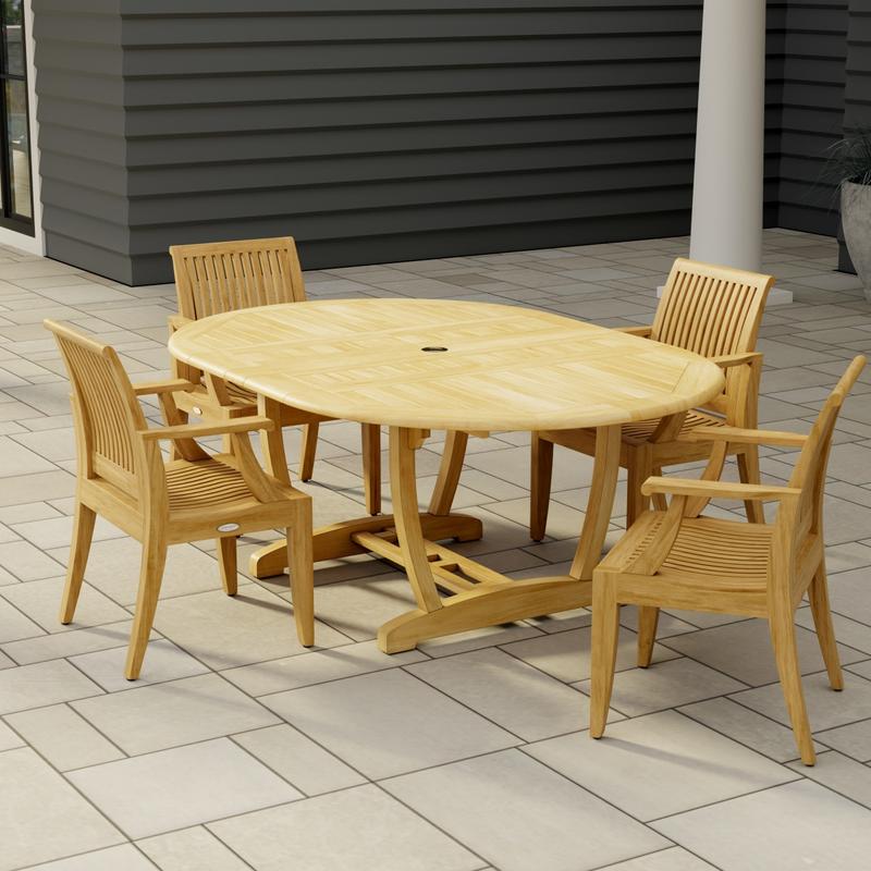 alt="70305 Martinique 5 piece Dining Set of Martinique Oval Dining Table and 4 Laguna Dining Chairs in angled end view on stone patio with a house and pillar in the background"