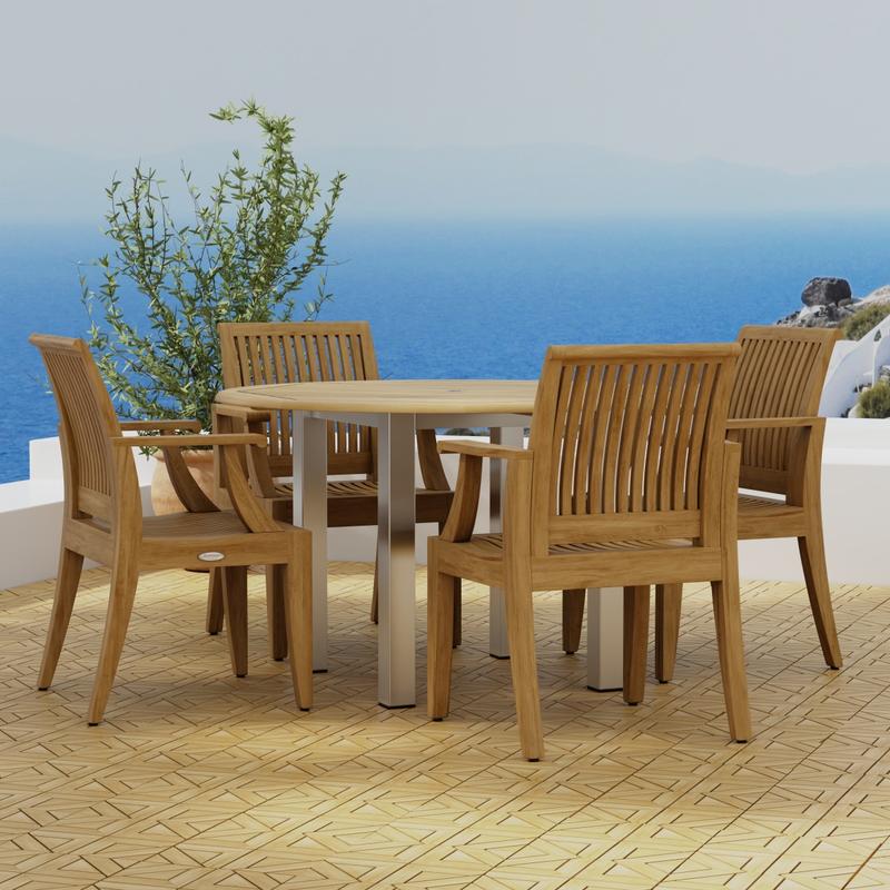 alt="70620 Vogue Laguna Dining Set of Vogue Stainless Steel and Teak 4 ft Round Table and 4 Laguna Teak Dining Chairs on Teak Parquet terrace with potted plant and ocean in background"