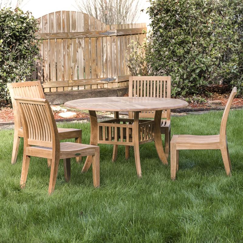 alt="70291 Hyatt Laguna 5 piece Dining Set on grass lawn with landscaped area with shrubs and wooden fence in background"
