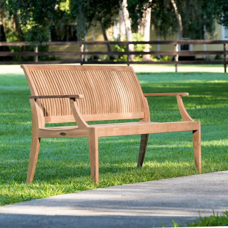alt="13812 Laguna 5 foot long Teak Bench on grass park with walkway in front and wooden fence and house in rear"